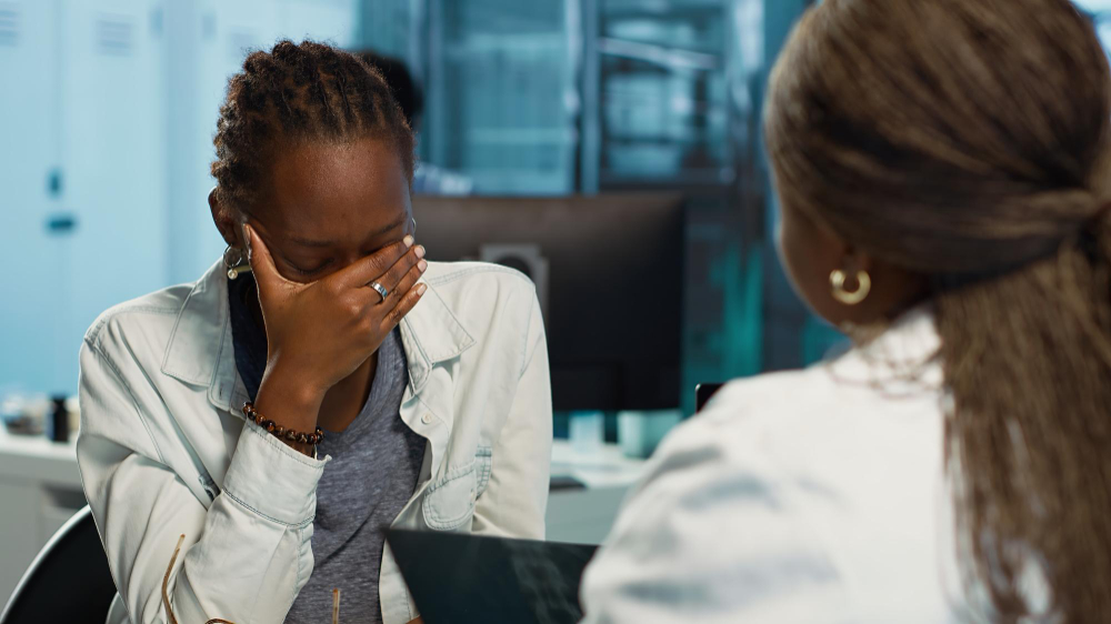 Older adult engaged in a purposeful, uplifting coaching conversation with a support worker