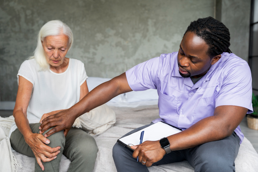 Support worker in a warm, empathetic conversation with a participant about grief and life change